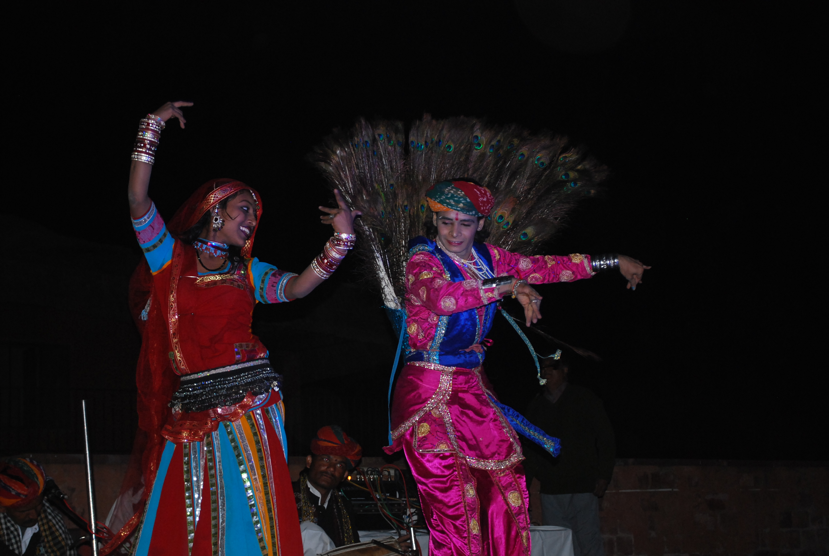 Rajasthani folk dancers performing beside a desert bonfire